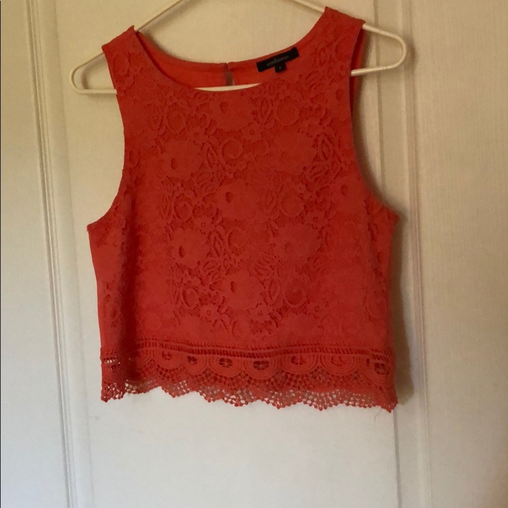 Salmon colored crop top with lace on the front